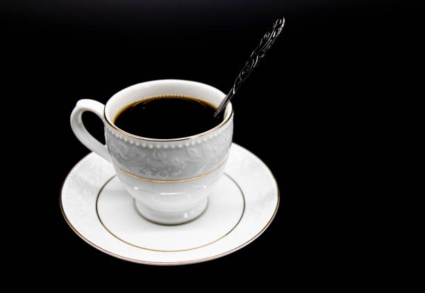 Black coffee and coffee beans on black background