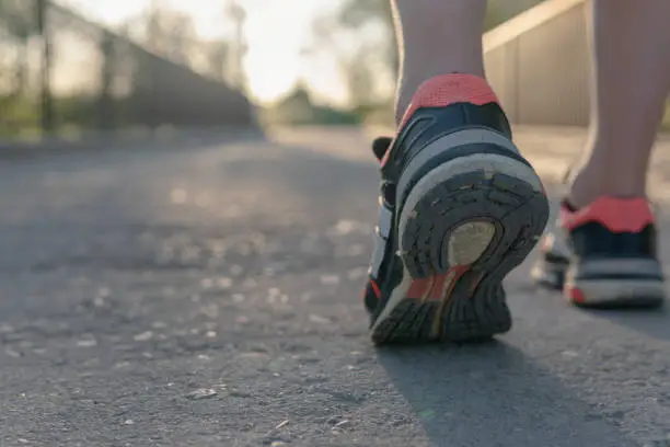 Photo of Runner's shoes advancing in the tread.