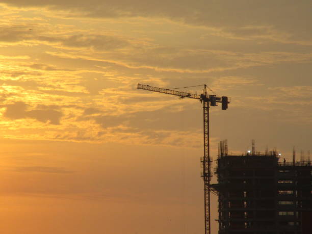 istock Crane next to building under construction at sunset 1400445636