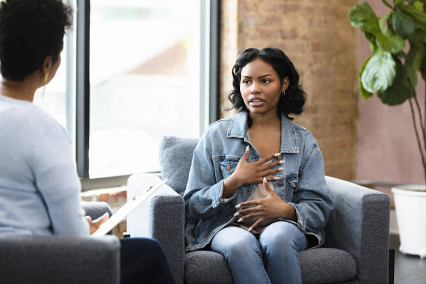 istock Teen gestures to herself while talking to unrecognizable counselor 1400445760