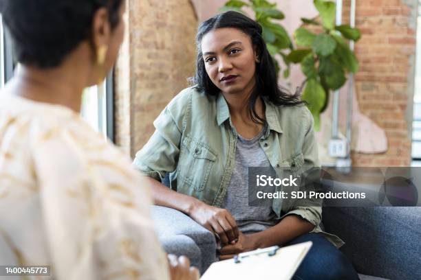 Young Woman Focuses On Female Counselors Advice Stock Photo - Download Image Now - Psychotherapy, Mental Health Professional, Alternative Therapy