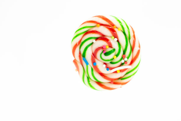 Sweet colorful lollipop on pink background, top view