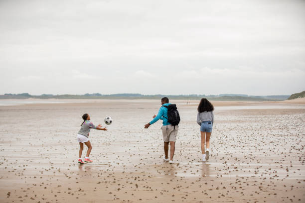 istock Playing Throw and Catch at the Beach 1400447358