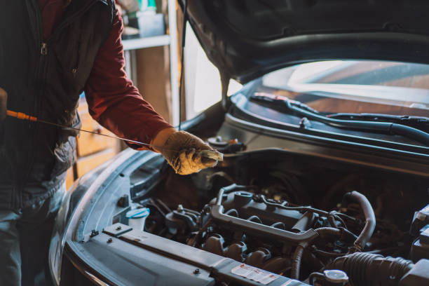 istock Mechanic wipes the engine oil level dipstick 1400447461