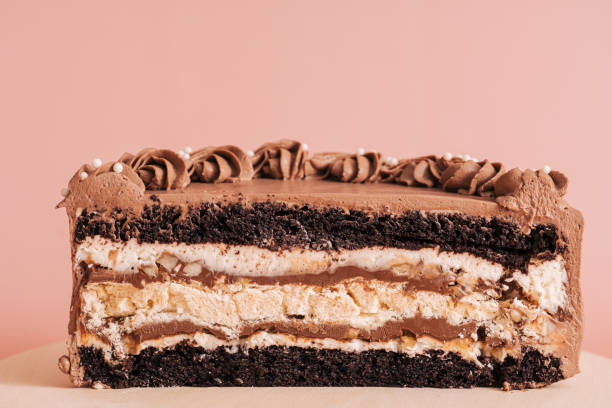 istock Piece of puff-chocolate cake against pink background 1400448026