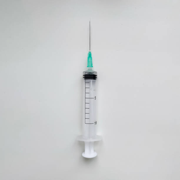 istock Disposable medical syringe with needle on white background. 1400449749