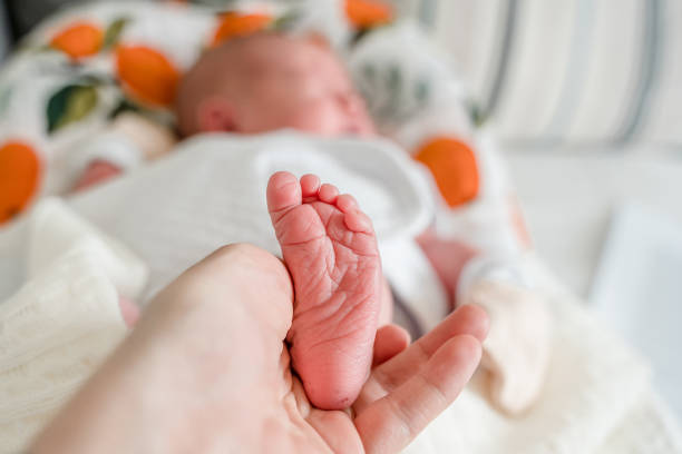 istock Small foot of a newborn baby, soft focus 1400450021