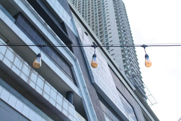 istock hanging decorative lights against the backdrop of tall buildings 1400450035