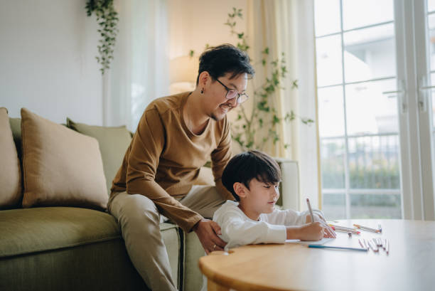 istock Asian child boy congratulating daddy on fathers day presenting gift 1400450914