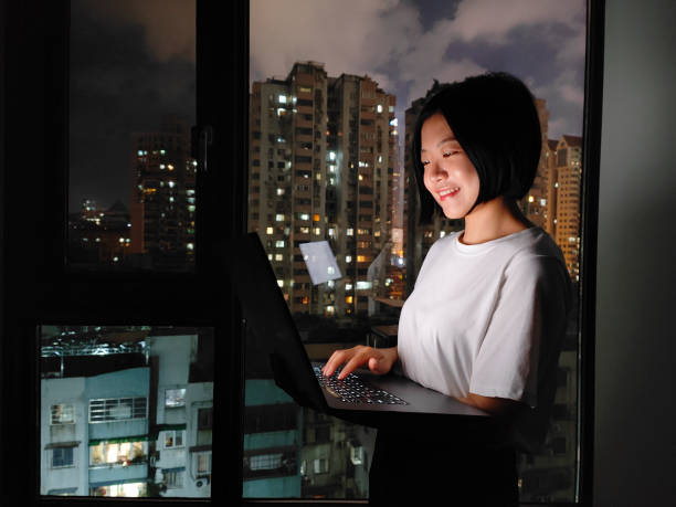 istock Asian woman working at home with laptop at night 1400451817