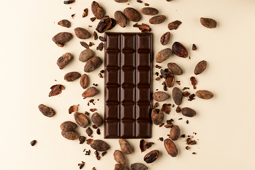 Gourmet and appetizing dark chocolate bar with cocoa beans. Healthy food.
