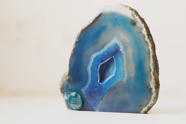 istock Large blue crystal of agate cross section isolated on white background. Natural translucent surface of agate crystal, blue abstract structural fragment 1400454369
