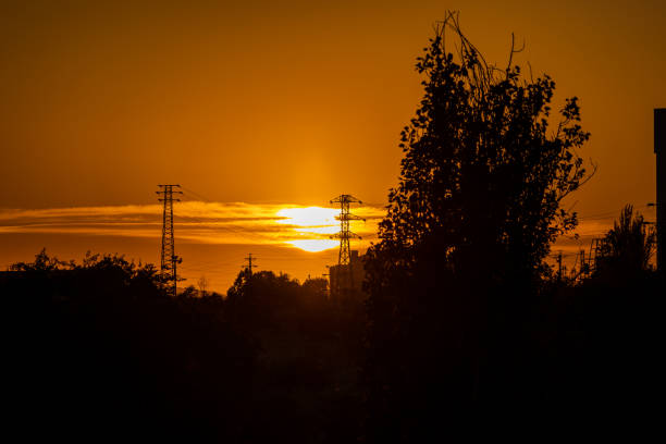 istock High voltage power transmission towers in Madrid at sunset. 1400455531