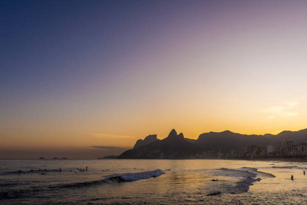 istock Beautiful beach sunset view with ocean, mountains and orange sky 1400456279