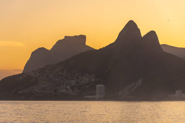 istock Beautiful beach sunset view with ocean, mountains and orange sky 1400456292