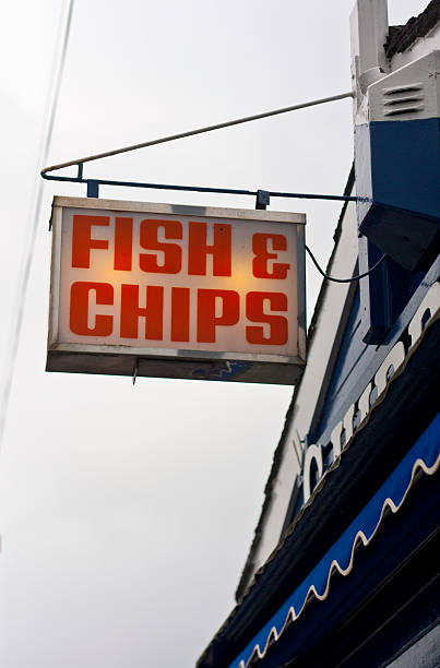Handwritten white text saying Fresh Fish, painted on blackboard with deep red borders.