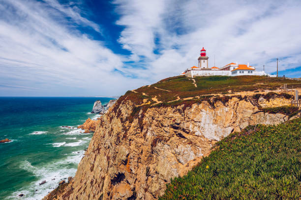 istock The lighthouse in Cabo da Roca. Cliffs and rocks on the Atlantic ocean coast in Sintra in a beautiful summer day, Portugal. Cabo da Roca, Portugal. Lighthouse and cliffs over Atlantic Ocean. 1400458294
