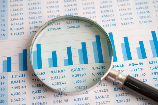 istock Magnifying glass on chart graph spreadsheet paper. Financial development, Banking Account, Statistics, economy, Stock exchange trading, Business office company meeting concept. 1400458544