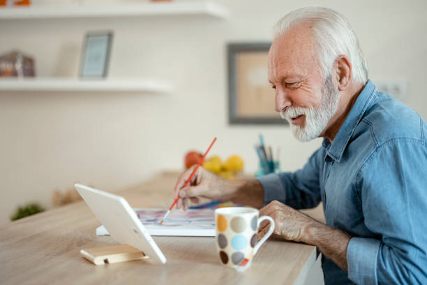 istock Senior Man Painting at Home 1400459583