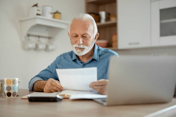 istock Senior Man Working With Financial Papers at Home 1400459824