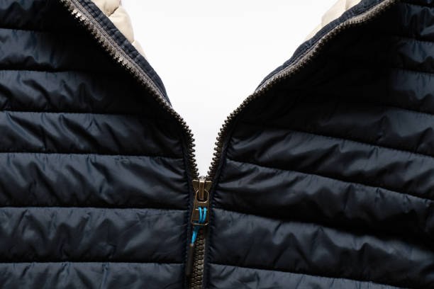 istock blue warm winter jacket with a lock in the middle as a background, clothes, a lock on clothes on a white background, perfect winter clothes, puffed jacket 1400459830