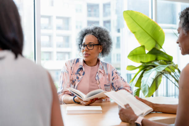 istock Senior woman listens to her group member 1400460072