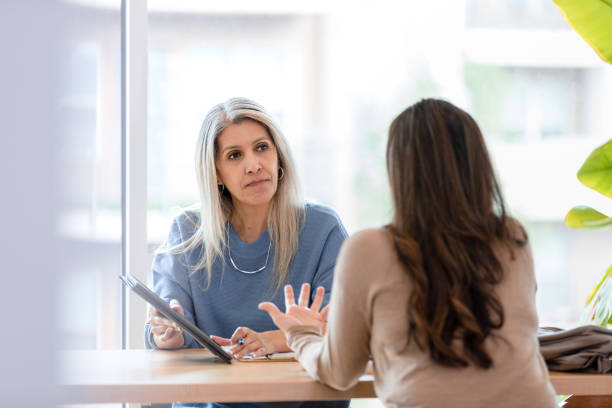 istock Financial advisor listens to her client 1400460096