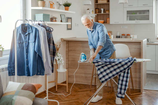 istock Senior Man at Home Ironing 1400460889