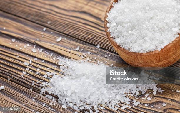 Salt In A Hodgepodge On A Wooden Table Stock Photo - Download Image Now - Close To, Crystal, Salt - Seasoning