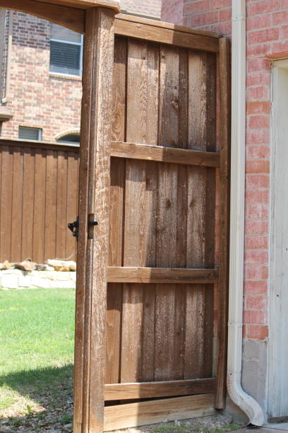 istock Hail damage on backyard fence gate 1400461225