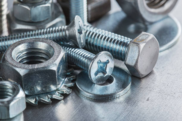 istock set of different nuts, bolts, screws, washers and drill bits,thread tap and mill cutters on steel plate background. Locksmithing deal. 1400462848
