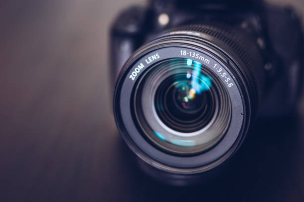 istock DSLR camera isolated on a black background. Black DSLR Camera isolated. Photo Camera or Video lens close-up on black background DSLR objective 1400463879