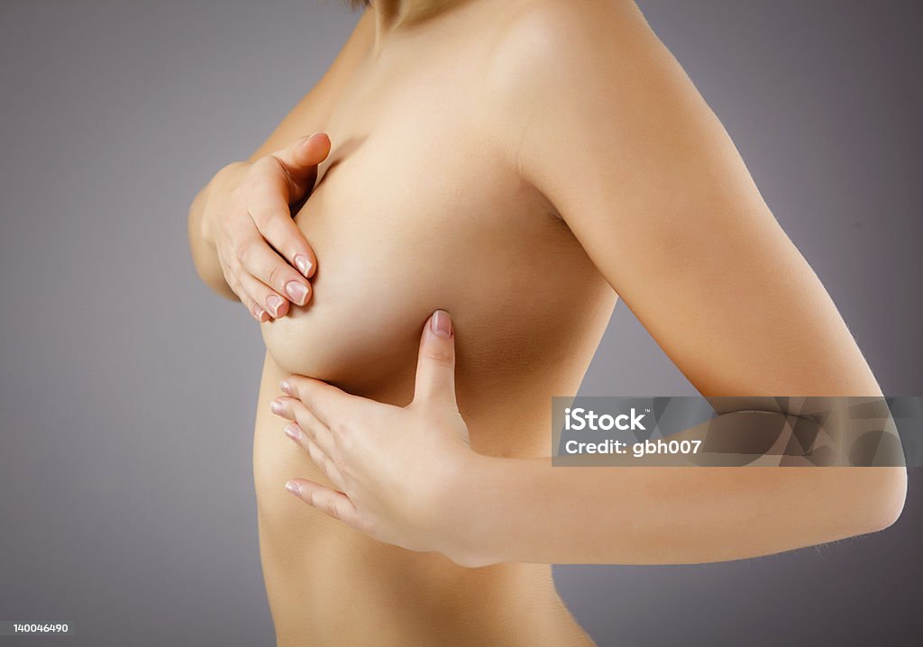 Woman examining her breast Breast examining  20-24 Years Stock Photo