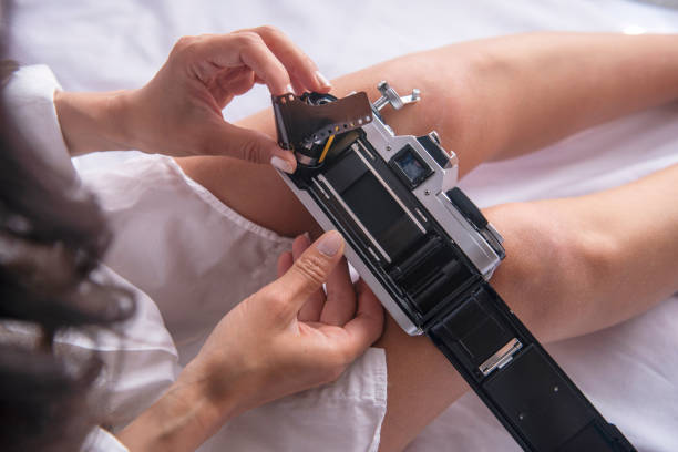 Young woman holds an analog camera. travel and vacation concept