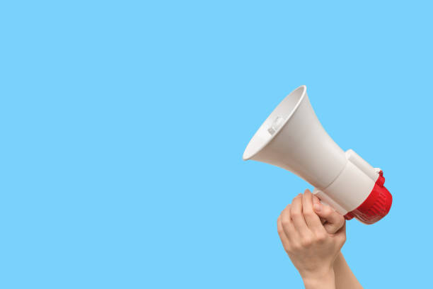 istock Megaphone in woman hands on a white background. 1400465564