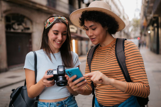 A diverse couple of female tourists exploring Barcelona stock photo