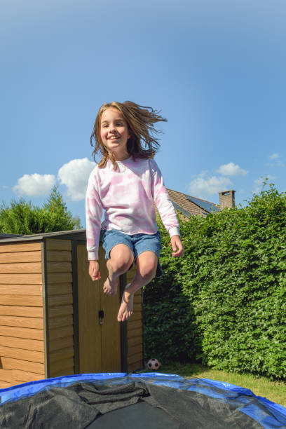 Girl jump on a trampoline. Have a great summer.