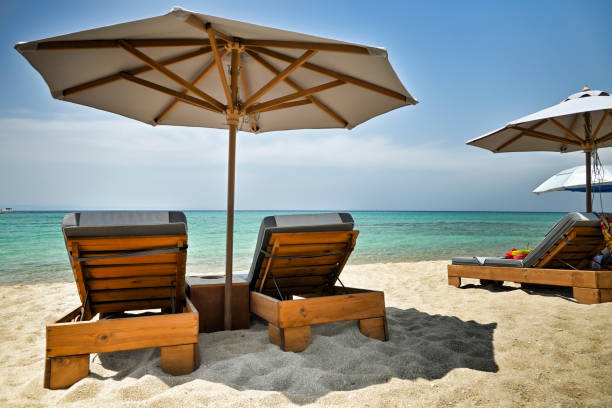 istock luxurious sunbeds and umbrella on beautiful beach 1400468966
