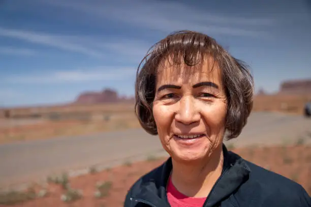 Middle Aged Indigenous Navajo Woman Portrait with Shallow Depth of Field in Monument Valley Utah on a Sunny Day