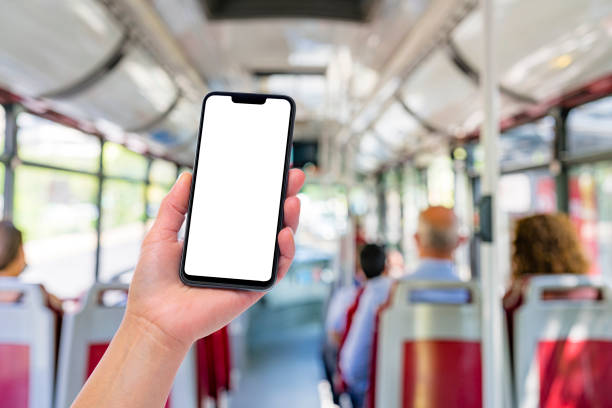 istock Hand holding blank screen smartphone inside public bus 1400471292