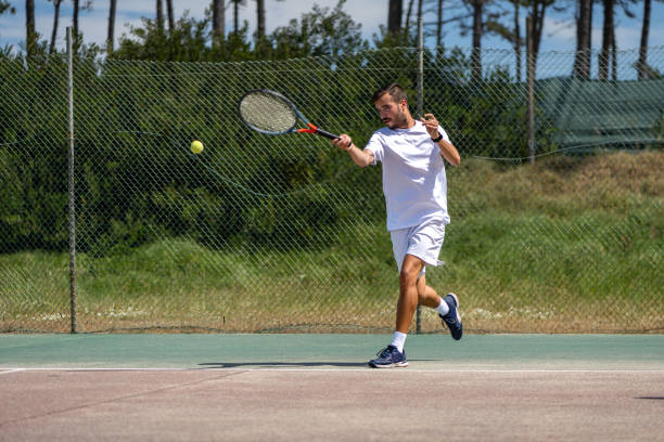 istock Tennis player hitting forehand at ball 1400472333
