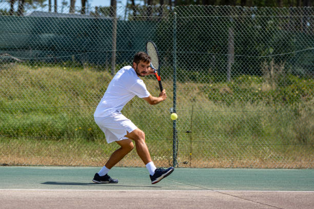 istock Tennis player hitting backhand at ball 1400472345