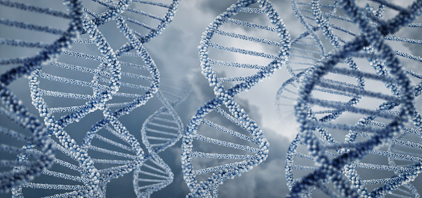 Helical DNA gene molecules on a blurred background.