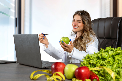 Female dietitian making video call with her client about diet plan online