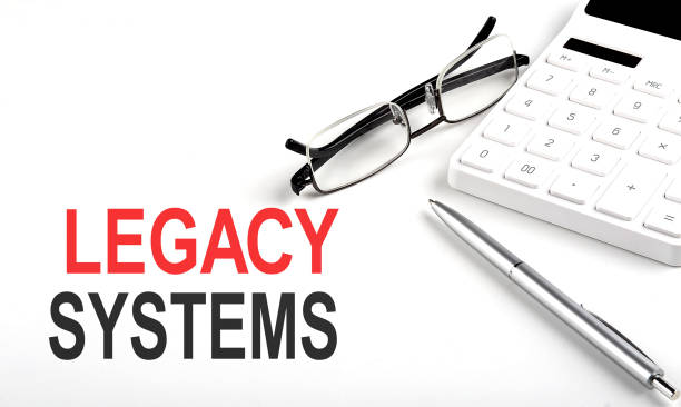 istock LEGACY SYSTEMS Concept. Calculator,pen and glasses on the white background 1400474047