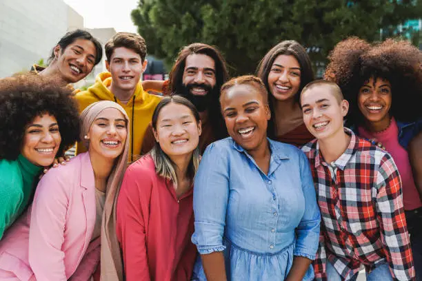 Photo of Multiethnic diverse group of people having fun outdoor - Diversity lifestyle concept