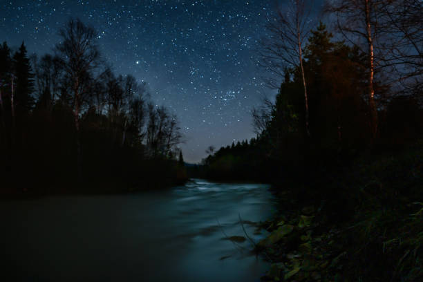 istock A magical starry night on the mountain river bank. 1400475457