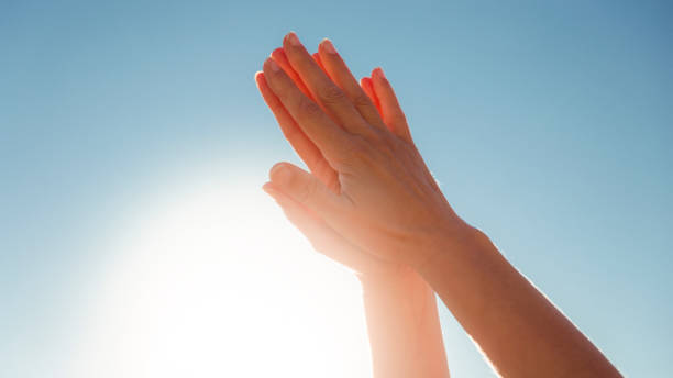 istock Hands raised to the sky in prayer position 1400475499