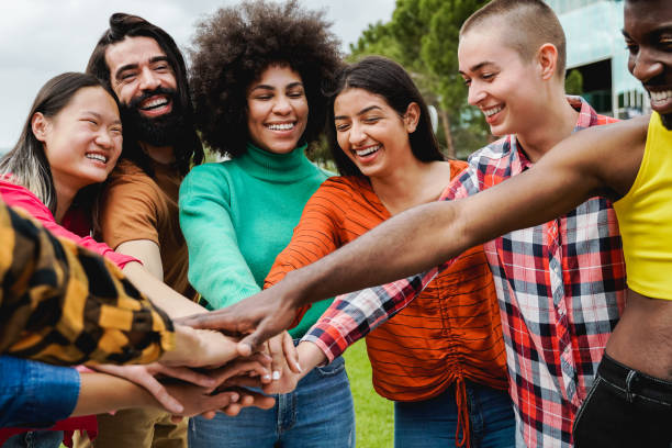 istock Young multiethnic group of people stacking hands together outdoor - Teamwork diversity and unity concept 1400475601