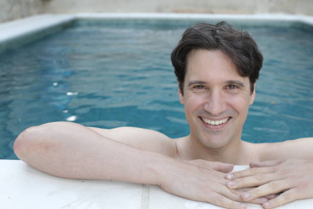 istock Man smiling in swimming pool 1400478103